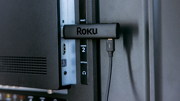 Roku Streaming Stick 4K plugged into the back of a TV